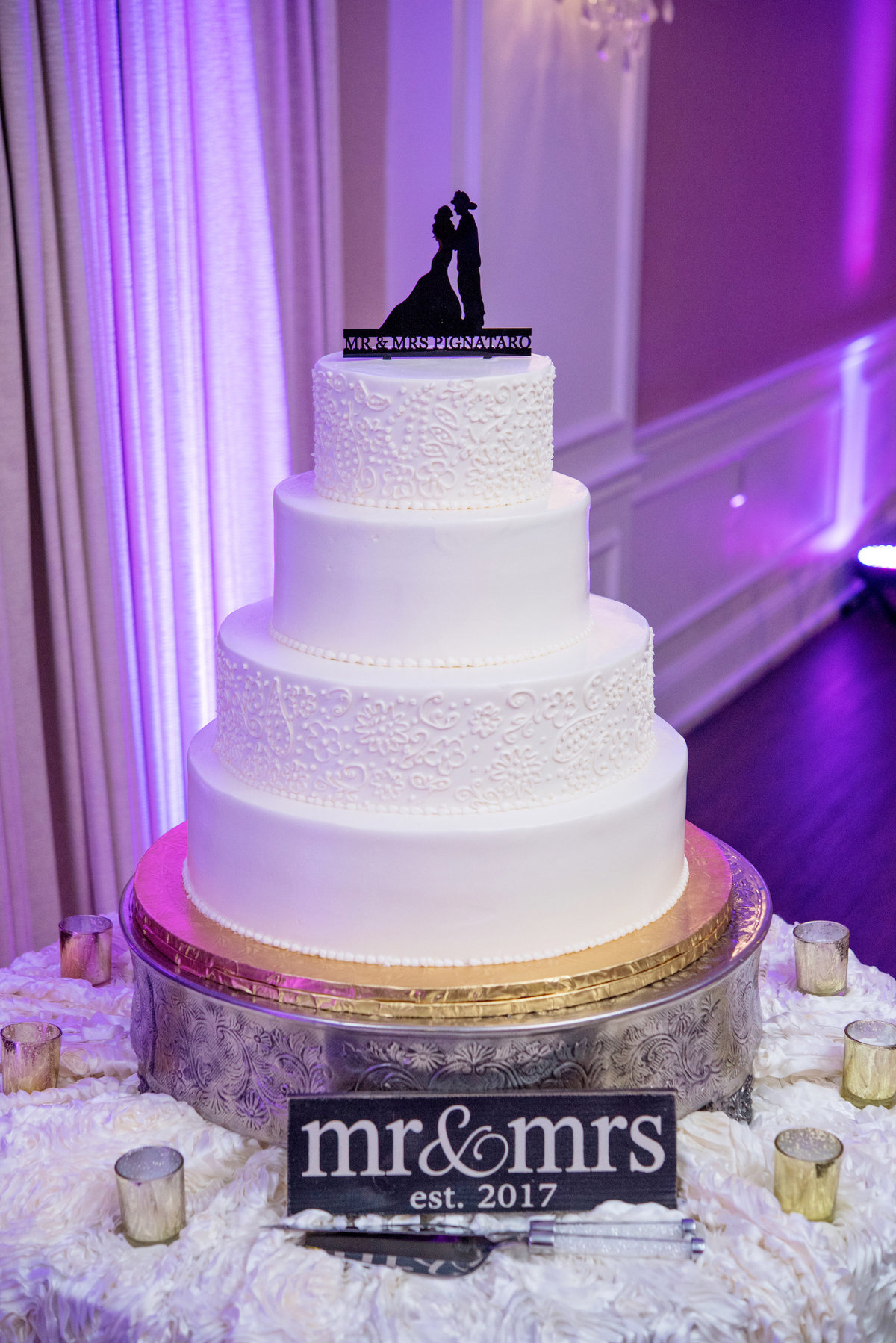 photo of wedding cake with engraved toppers from wedding reception at Lawrence Yacht and Country Club