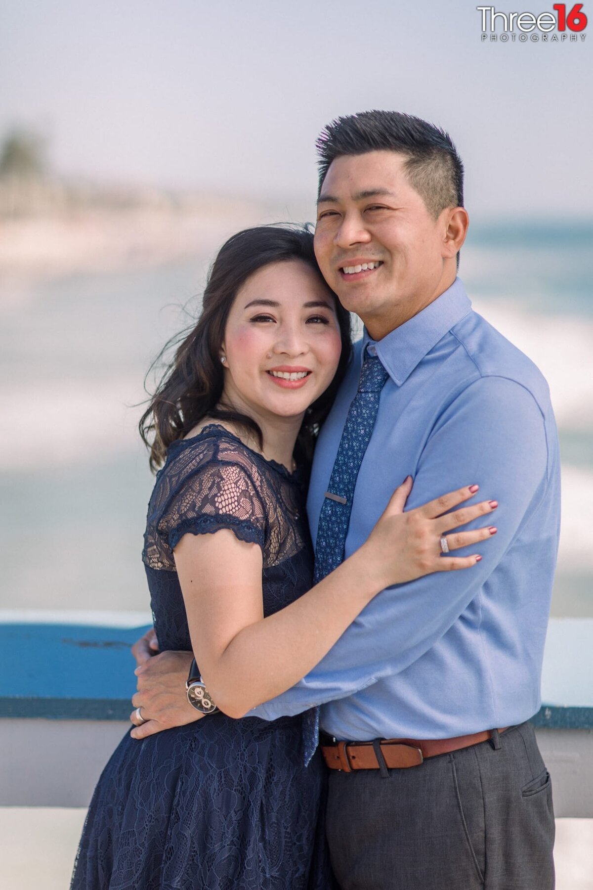 Engaged couple embrace each other during photo shoot