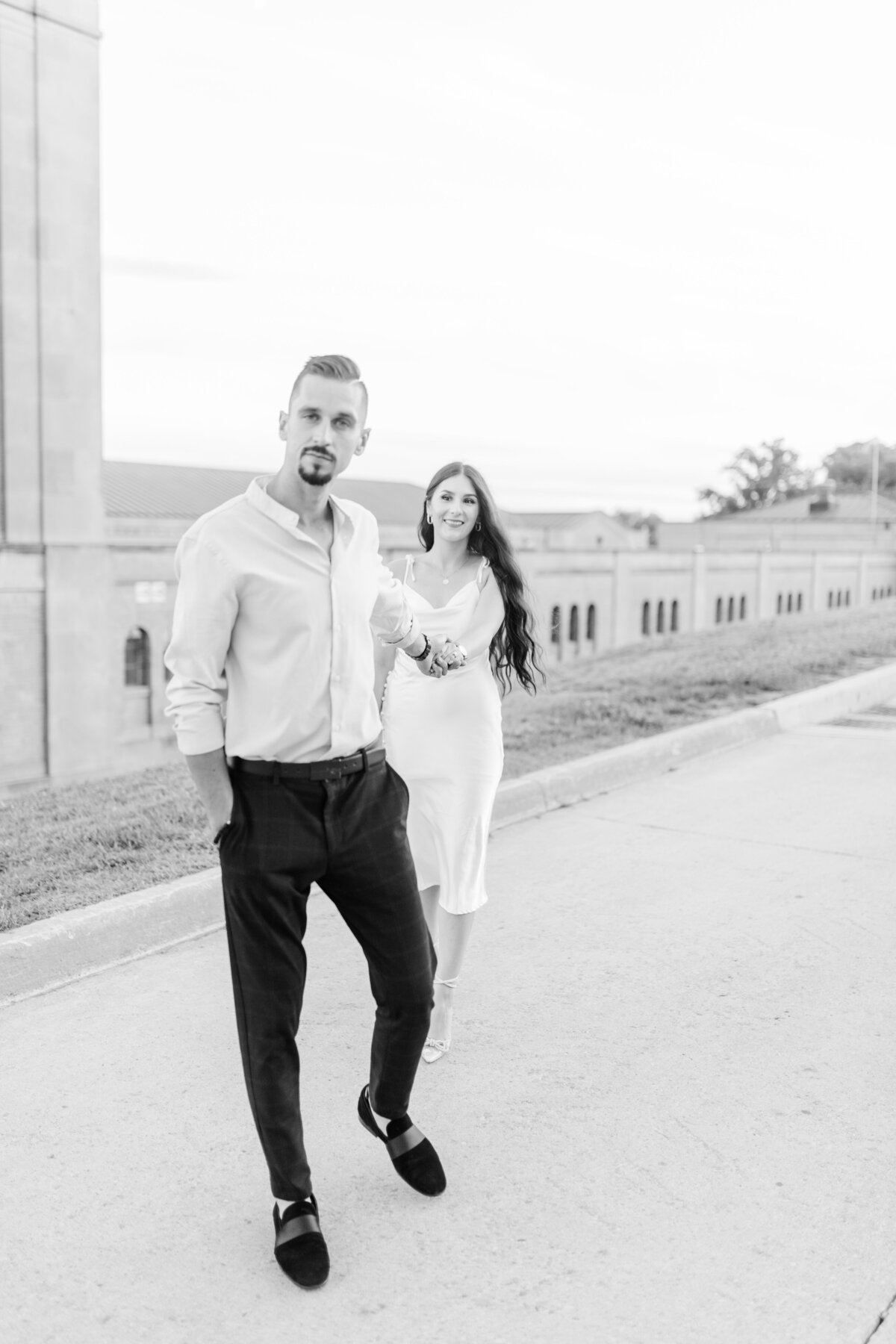 Engaged couple walking hand-in-hand along a quiet street in Burlington, Ontario