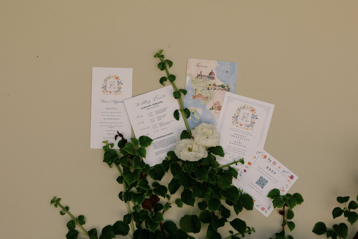 Flatlay of invitation suite and details for a Tuscany destination wedding