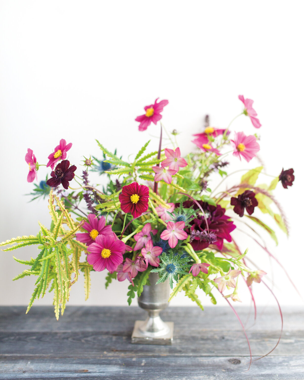 A floral garden arrangement of bright pink flowers at a Montreal wedding reception.