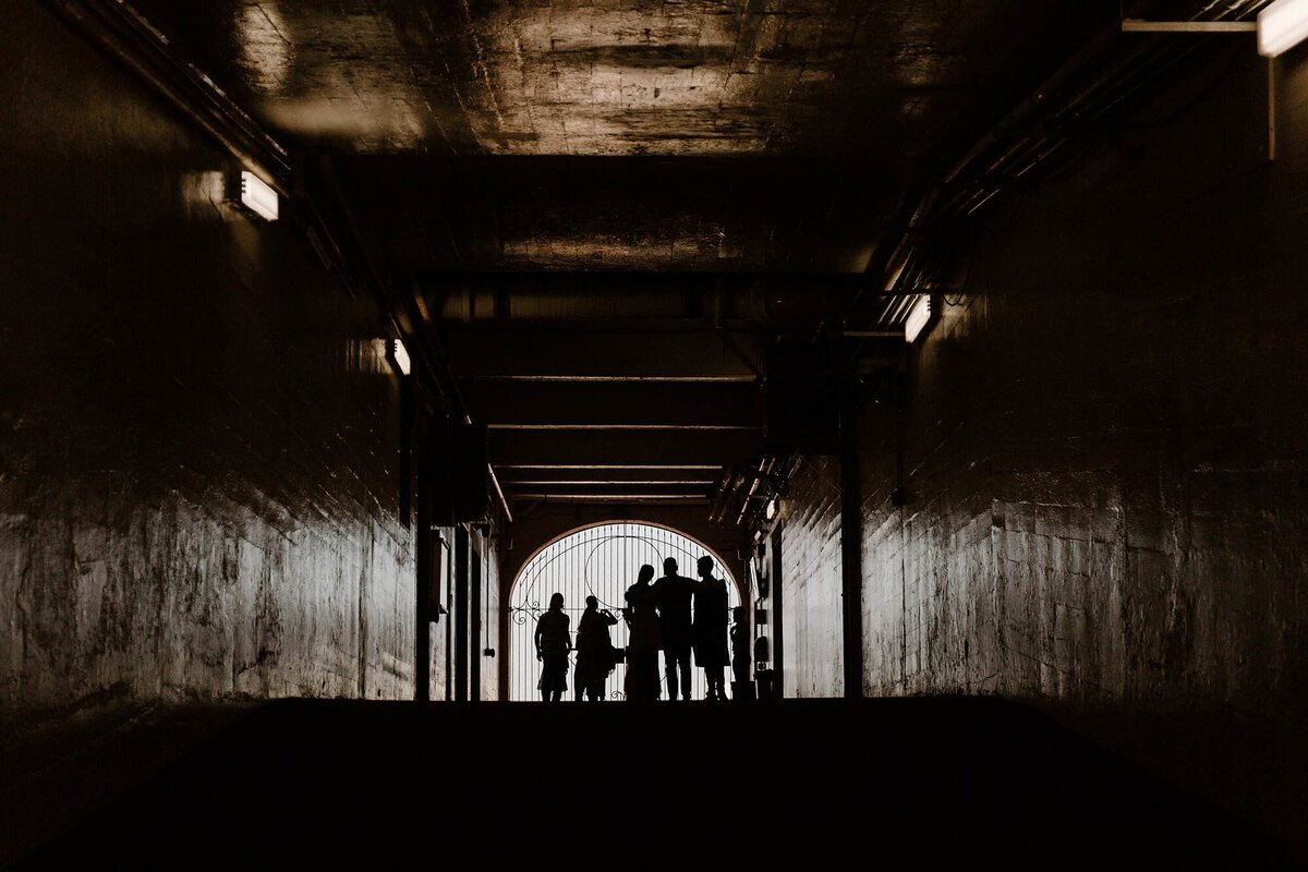 A family standing in a tunnel together 