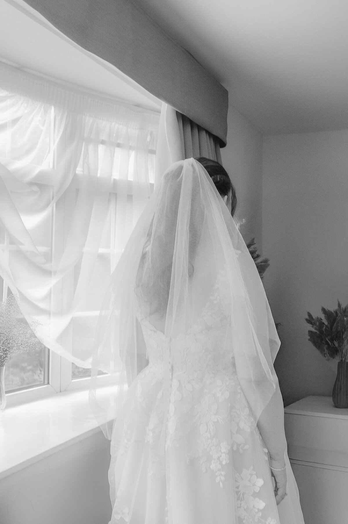 black and white photo of emotional bride photo showing her veil - cheshire wedding photographer