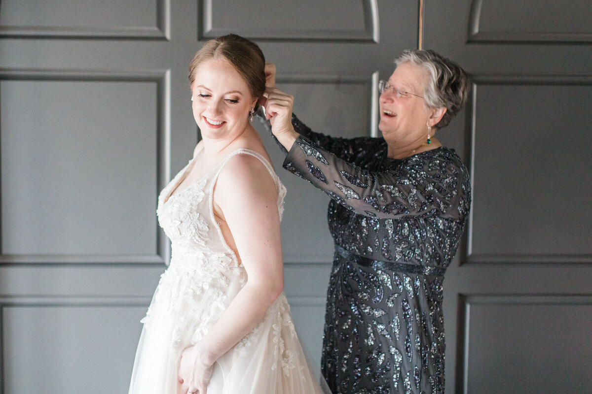 Mother of the bride fixing brides hair
