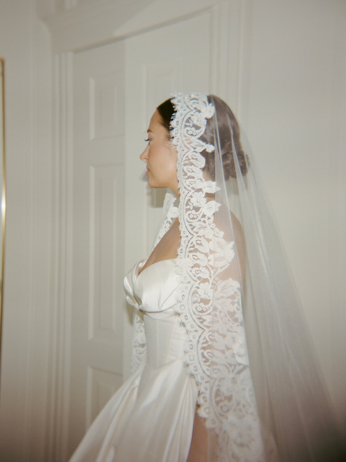 flash film photography with editorial flare, a bride in lace mantilla veil at 1 Room Hotel Detroit