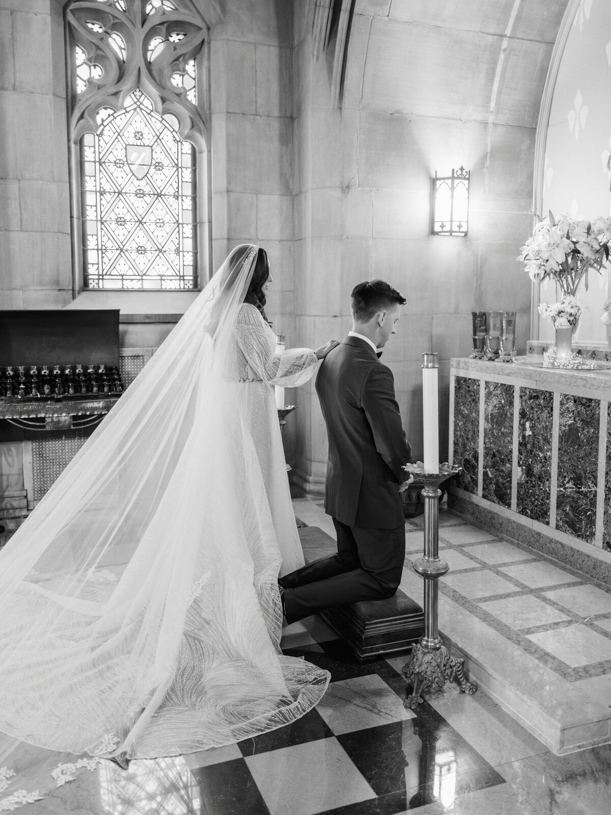Bride and groom praying to Mary at St Cecilia Catholic Church wedding in Cincinnati, Ohio