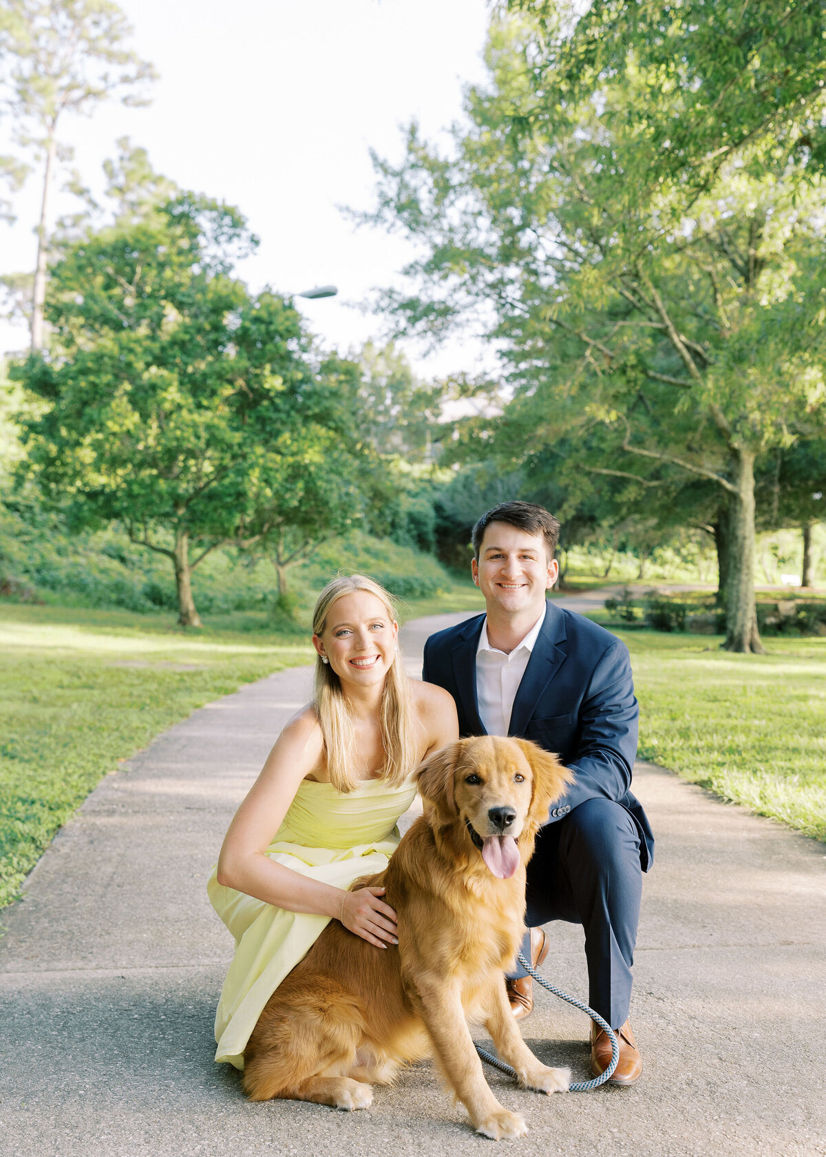 a couple posing for a photo with their dog