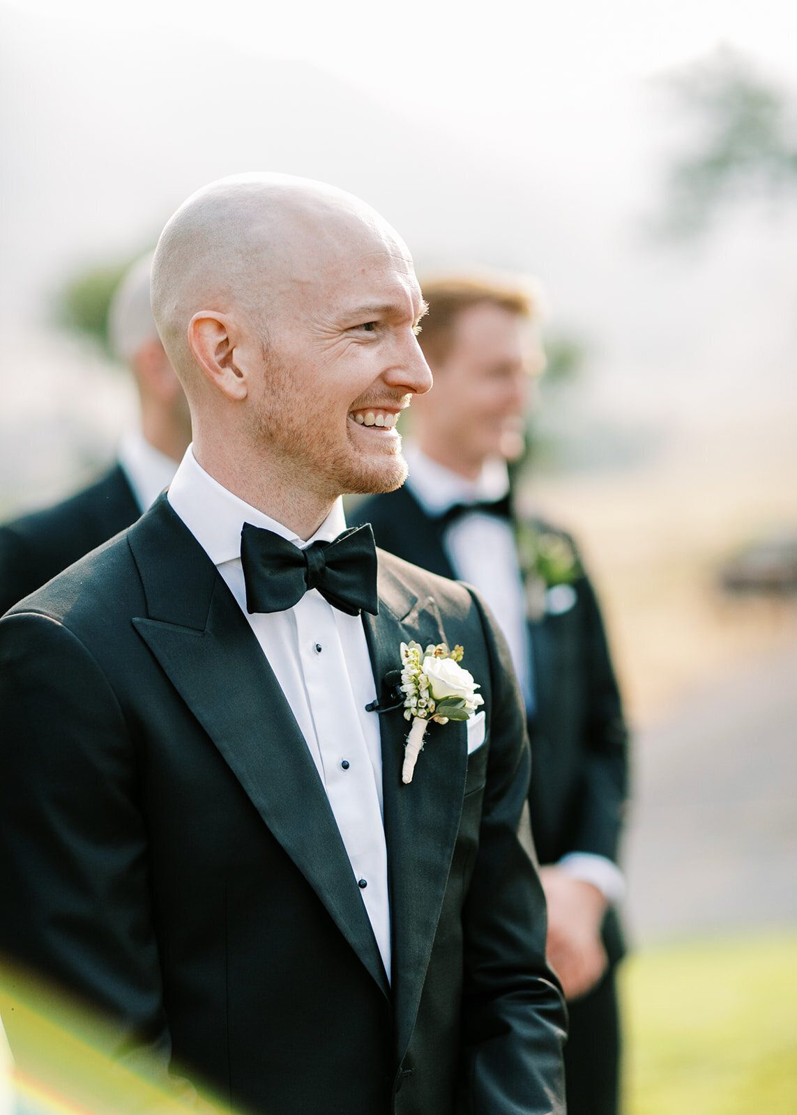Groom smiling at the altar