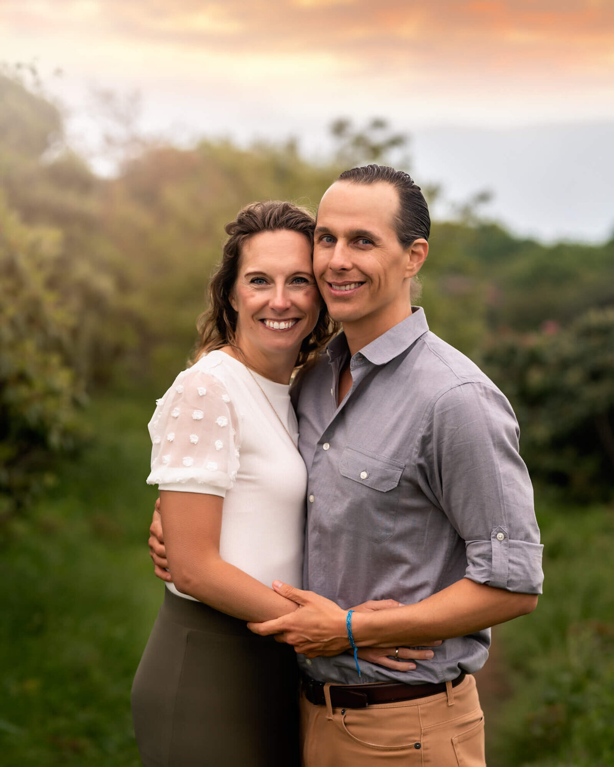 A beautiful couple hugging and smiling  during their portrait session with an Asheville Family Photographer