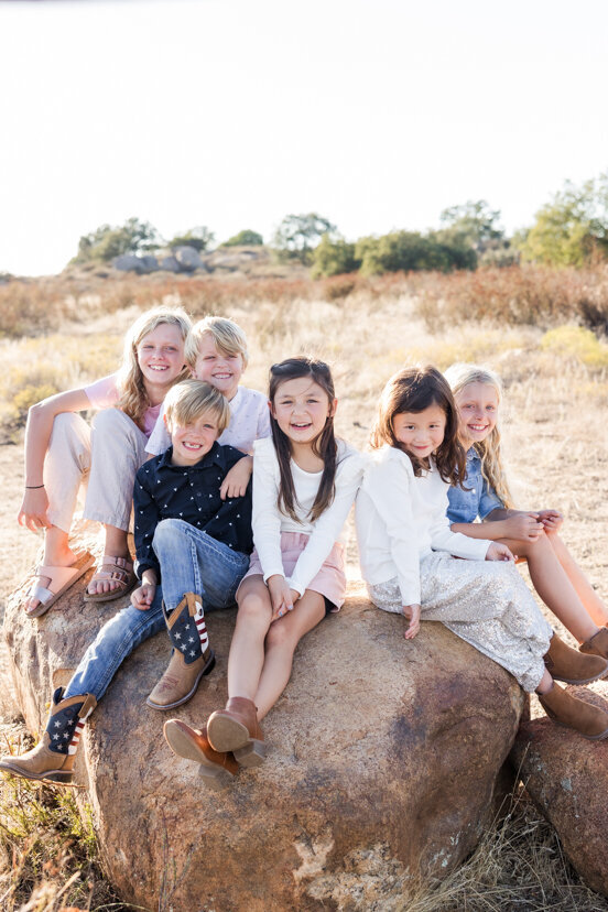 cousins-sitting-on-rock-family-of-four-sitting-on-rock-wrights-field-san-diego