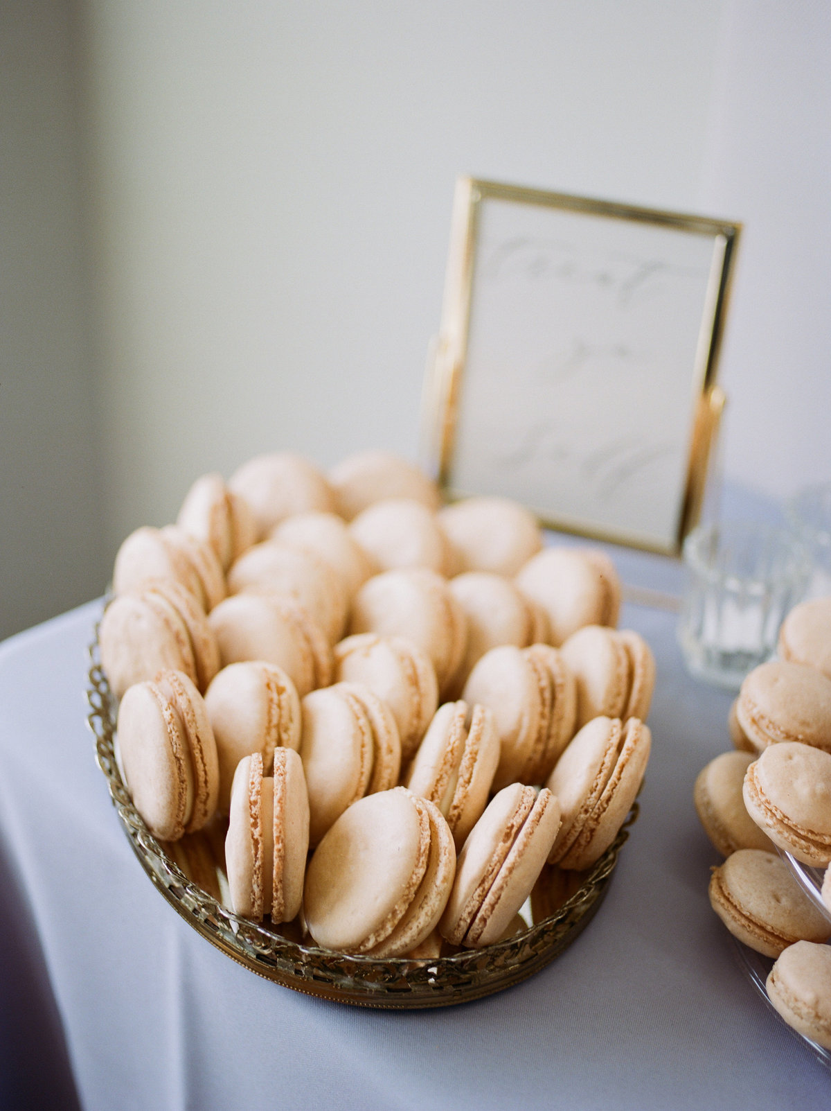 gold macaroons sitting in bowl