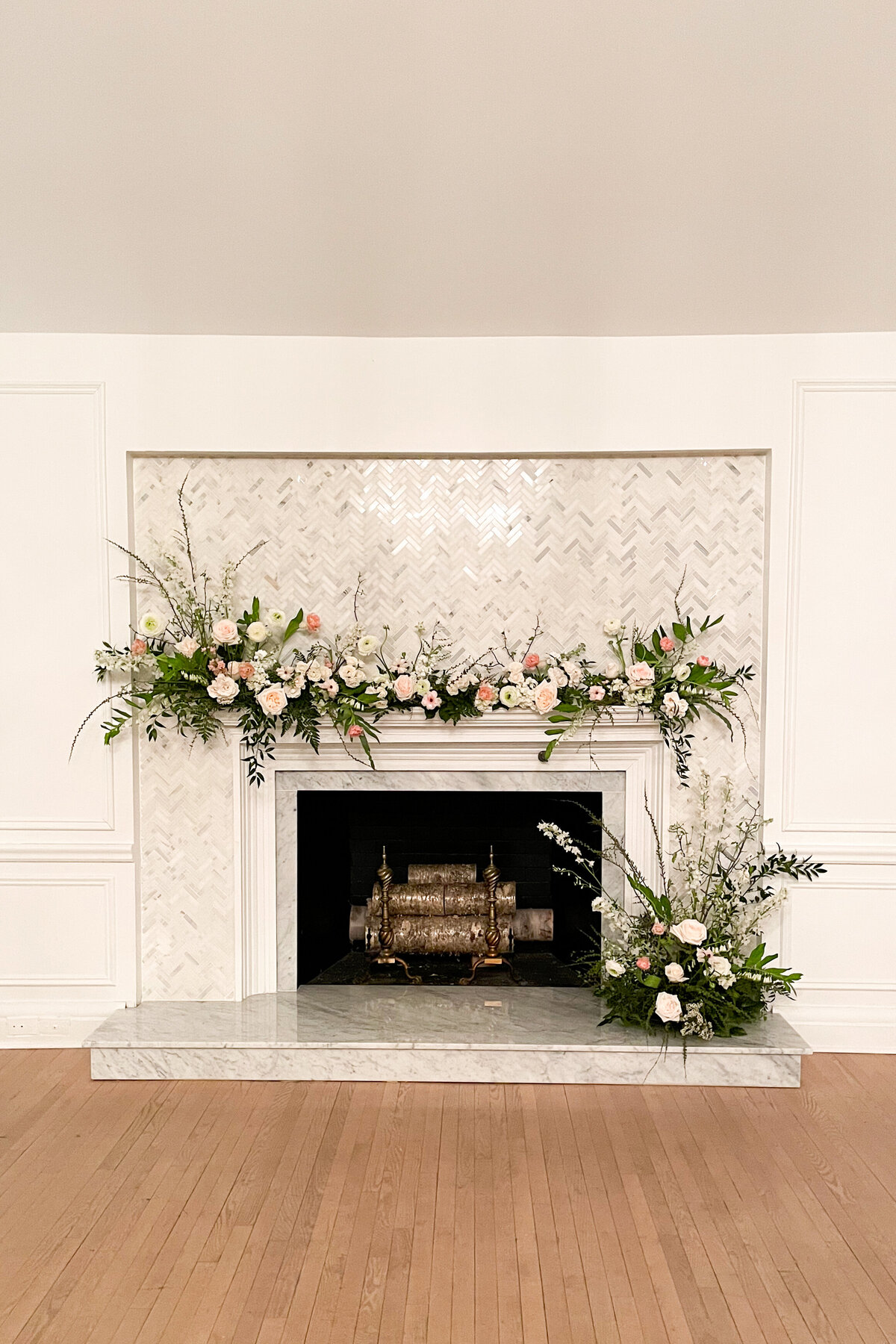 A meadow of garden flowers on a fireplace decorate a wedding ceremony at the Atwater Club.