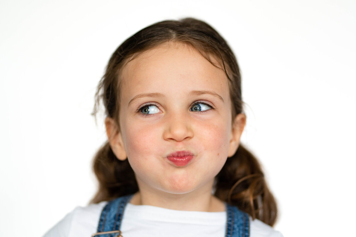 School photo of little girl making a silly face showing her personality