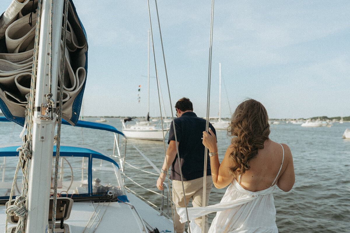 couple walking on boat during engagement photos, captured by Elsie Goodman, an NYC engagement and couples photographer