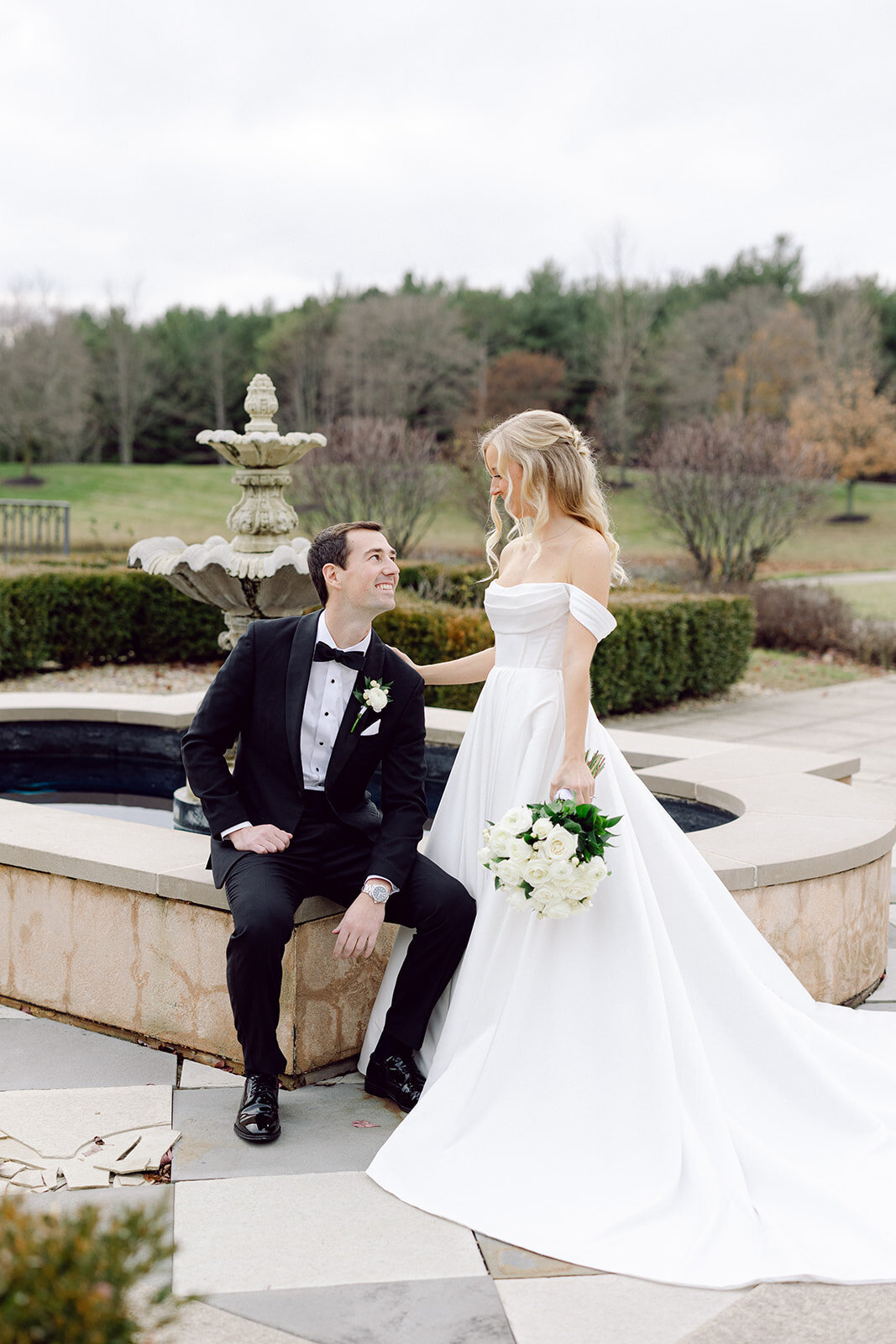 Bride & Groom beside a fountain at a beautiful Columbus wedding venue shot by a philly wedding photographer