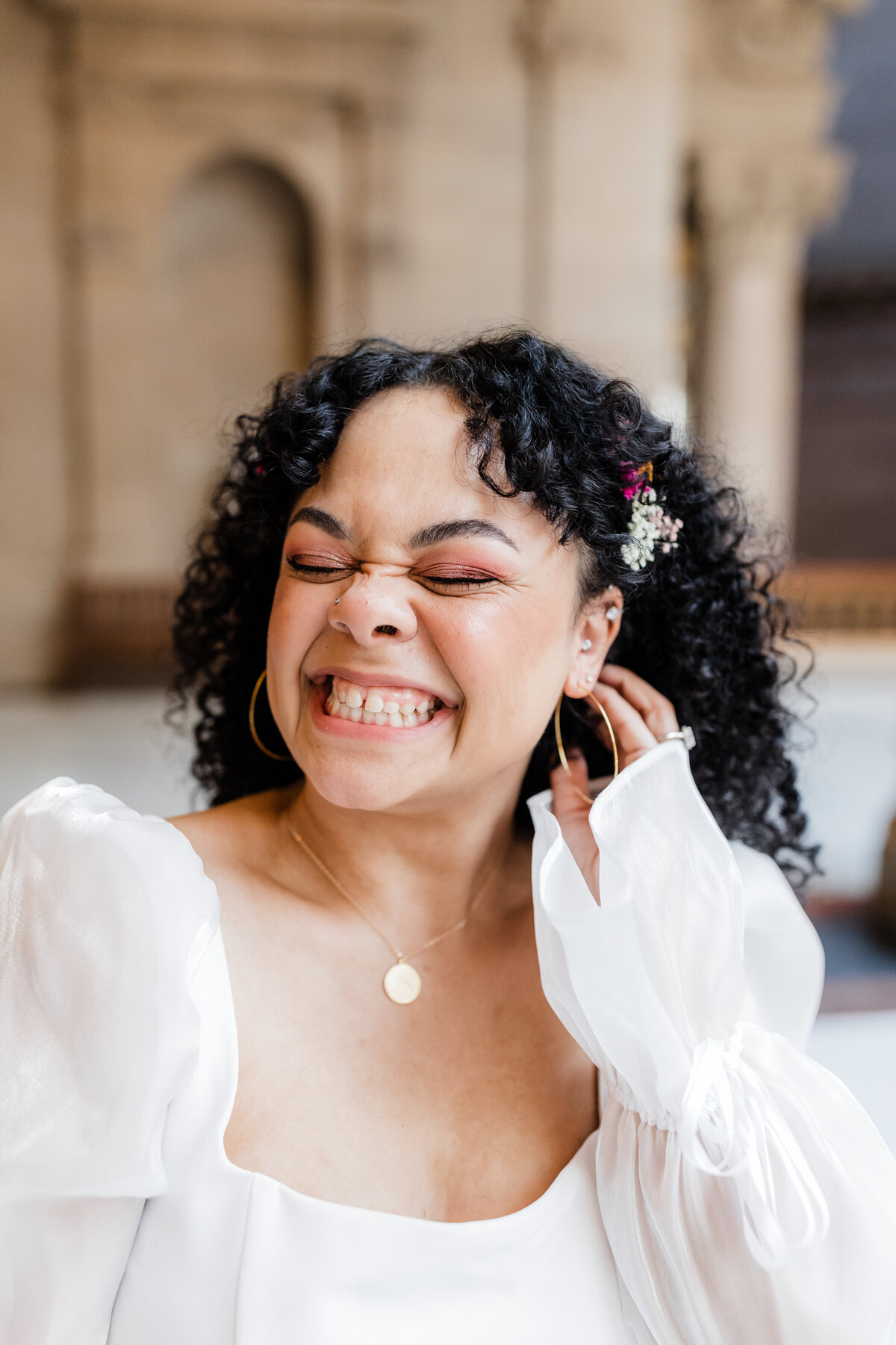 Joyful bride smiling while getting ready for her South Bend wedding.