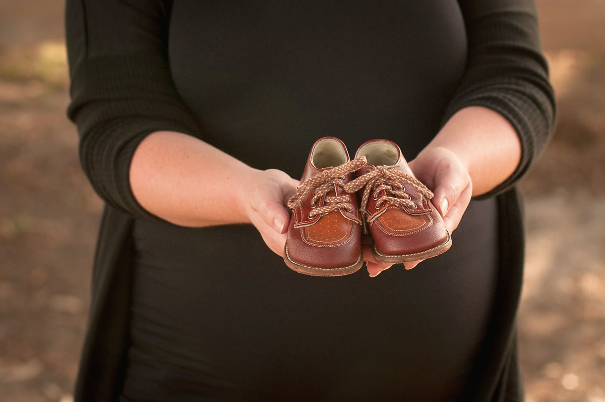 Maternity Poses with Baby Shoes