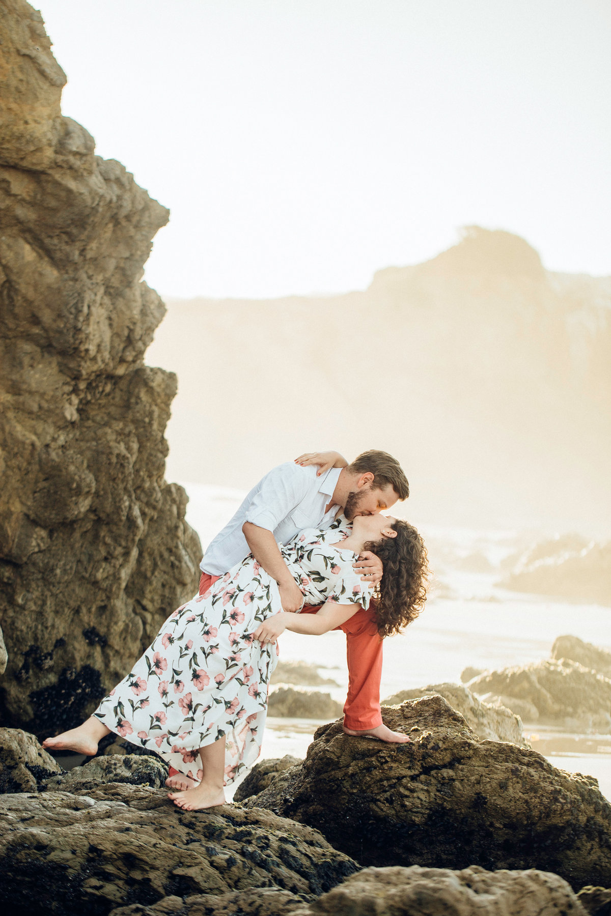 Engagement Photograph Of  Man And Woman Bending While Kissing Los Angeles
