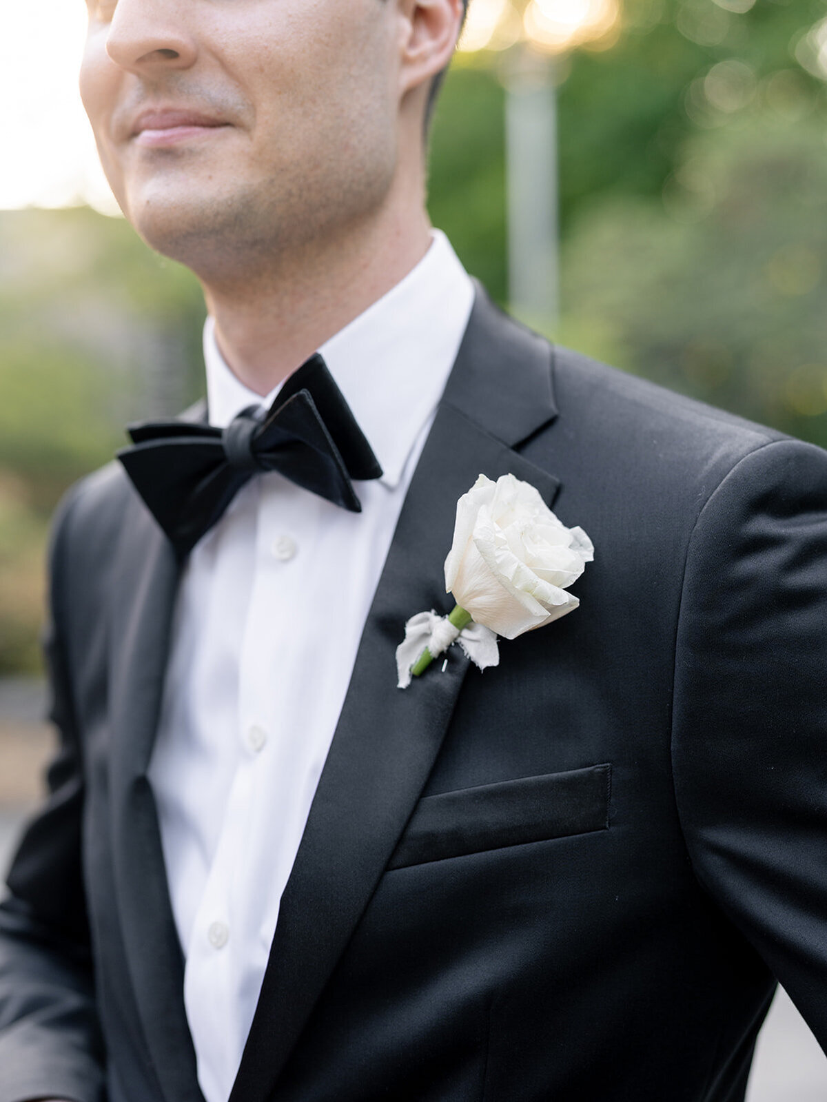 a groom in a sleek black tuxedo