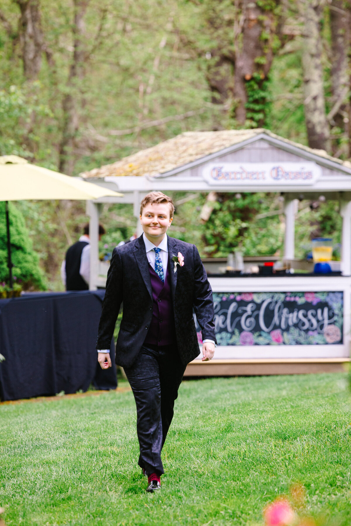 Bride in suit walking down the wedding aisle