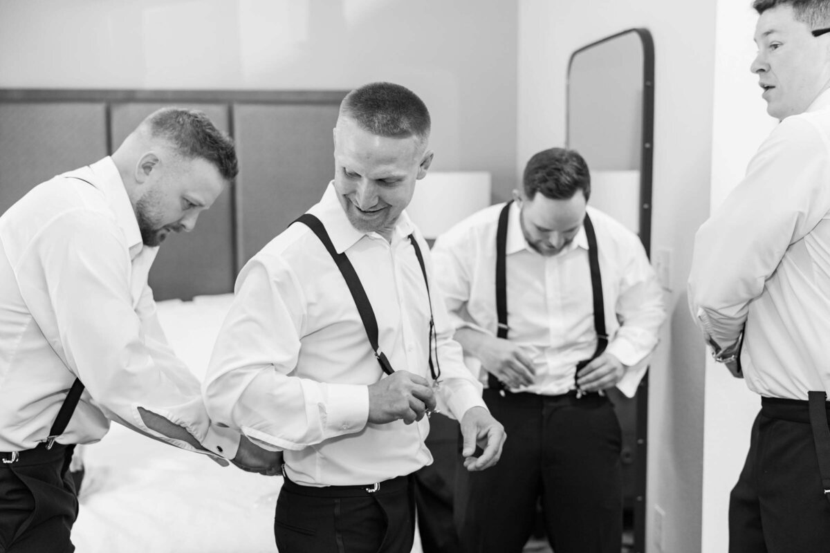 groomsman-getting-ready-black-and-white-smiling