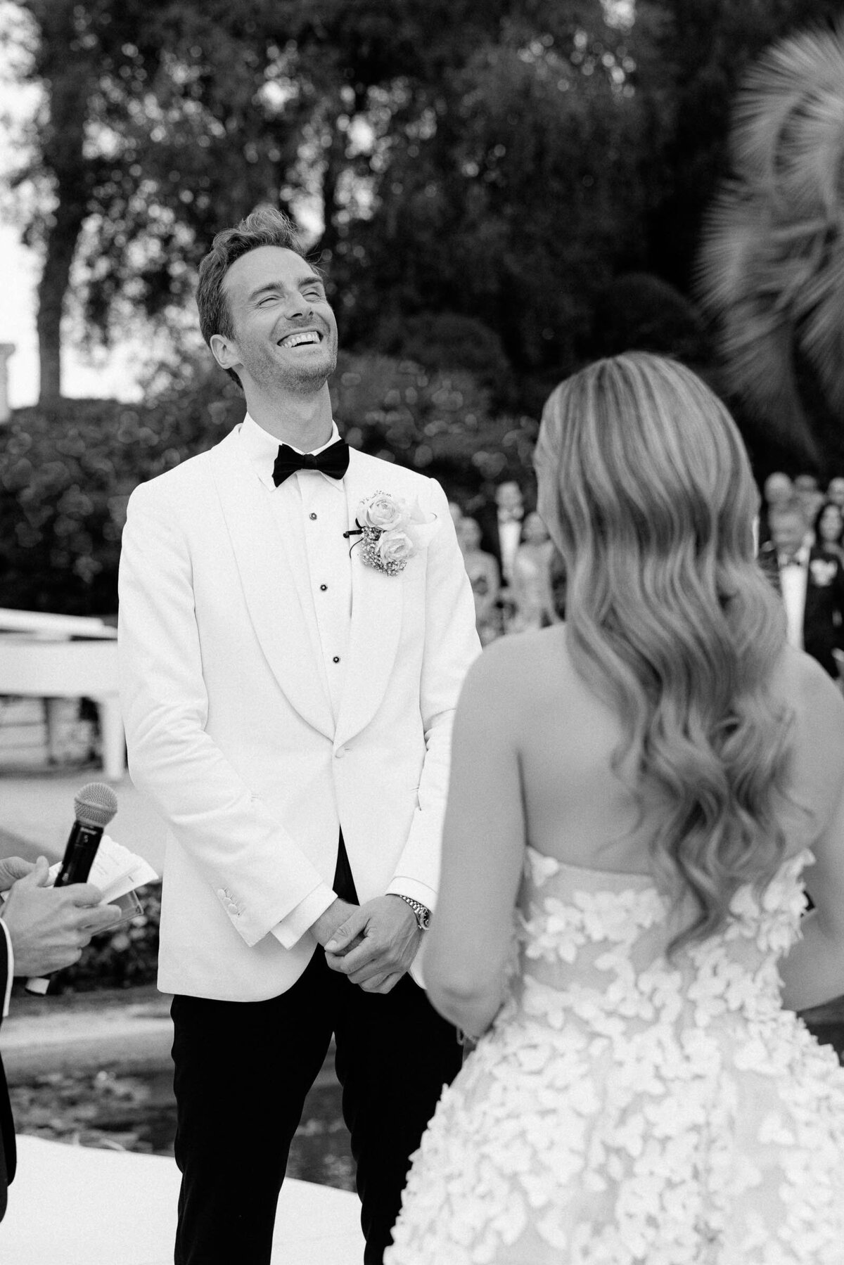 Groom is laughing during the wedding ceremony.