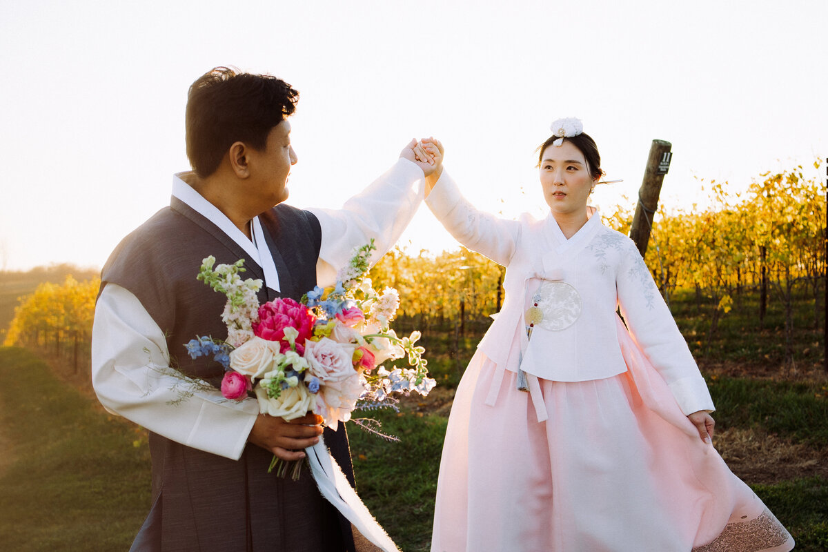 happy Asian couple holding hands outside
