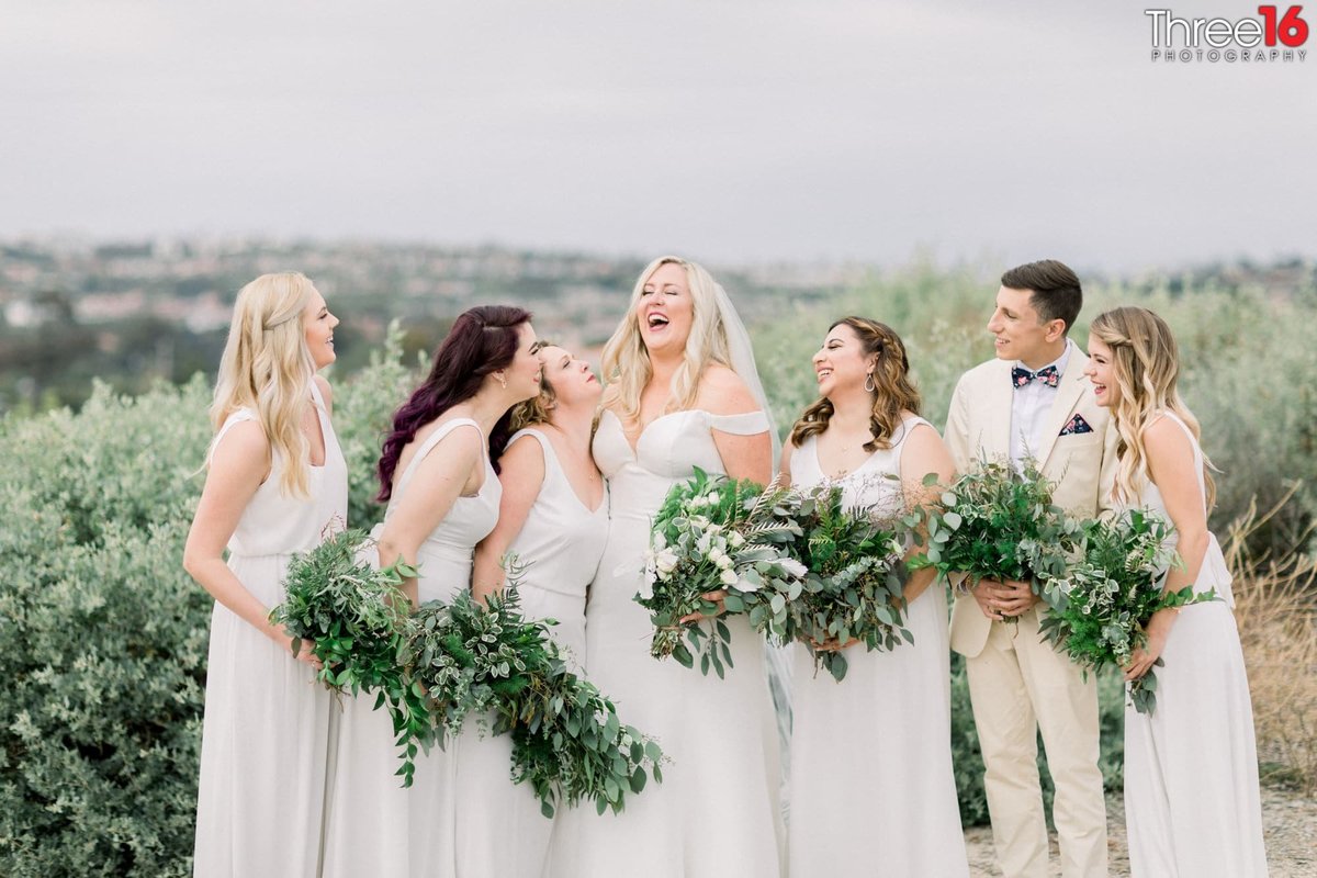 Bride shares a big laugh with her Bridesmaids