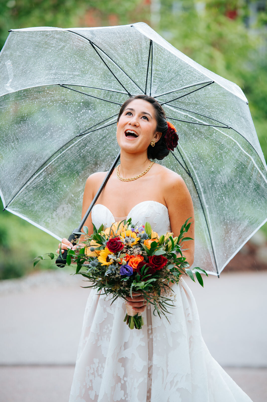 bride dancing with umbrella in rain at sugarbush resort vermont wedding