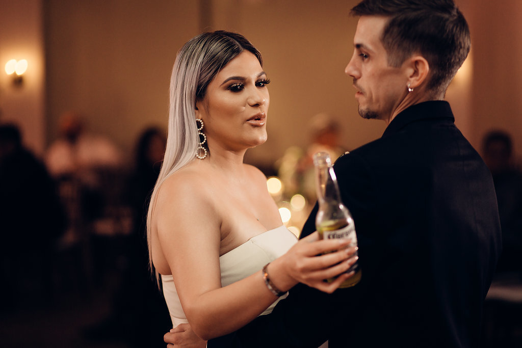 Wedding Photograph Of a Woman Holding a Bottle While Dancing With The Groom Los Angeles