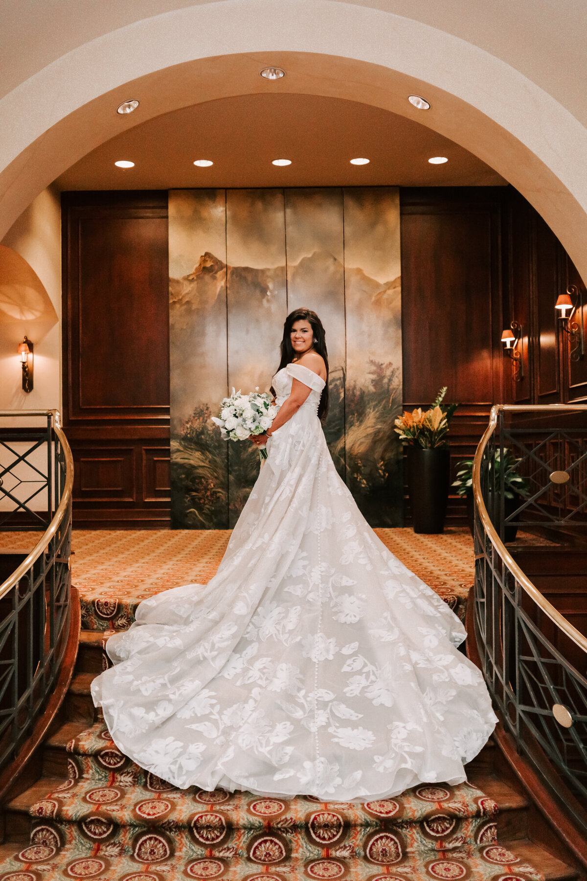bride stands on houstonians staircase in houston texas