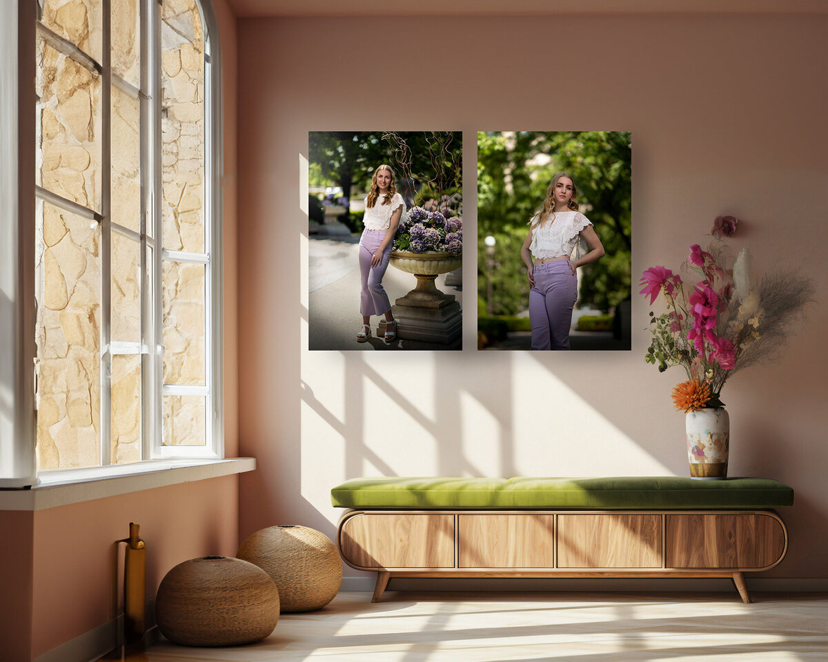 Two senior graduate fine art prints hang on a wall above a wood lounger