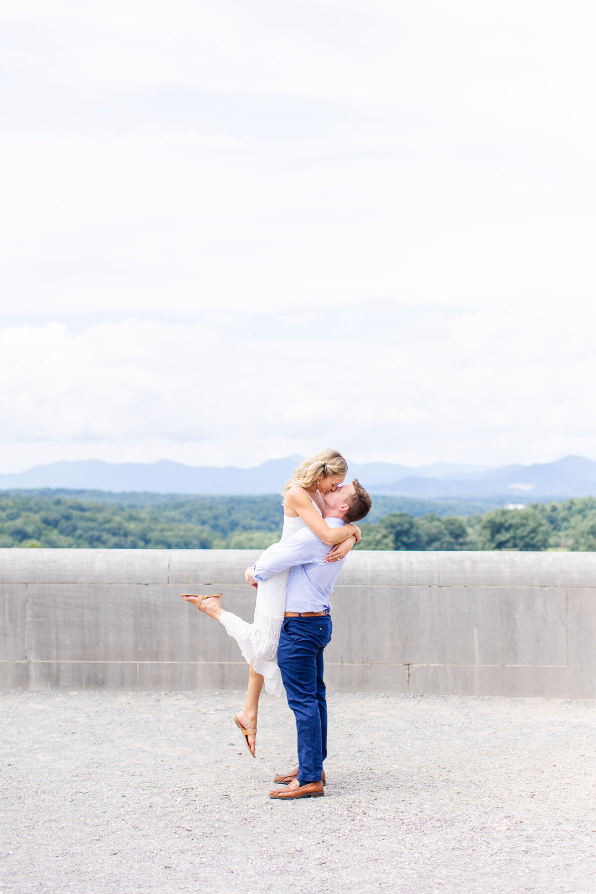 guy holding girl up with mountain views