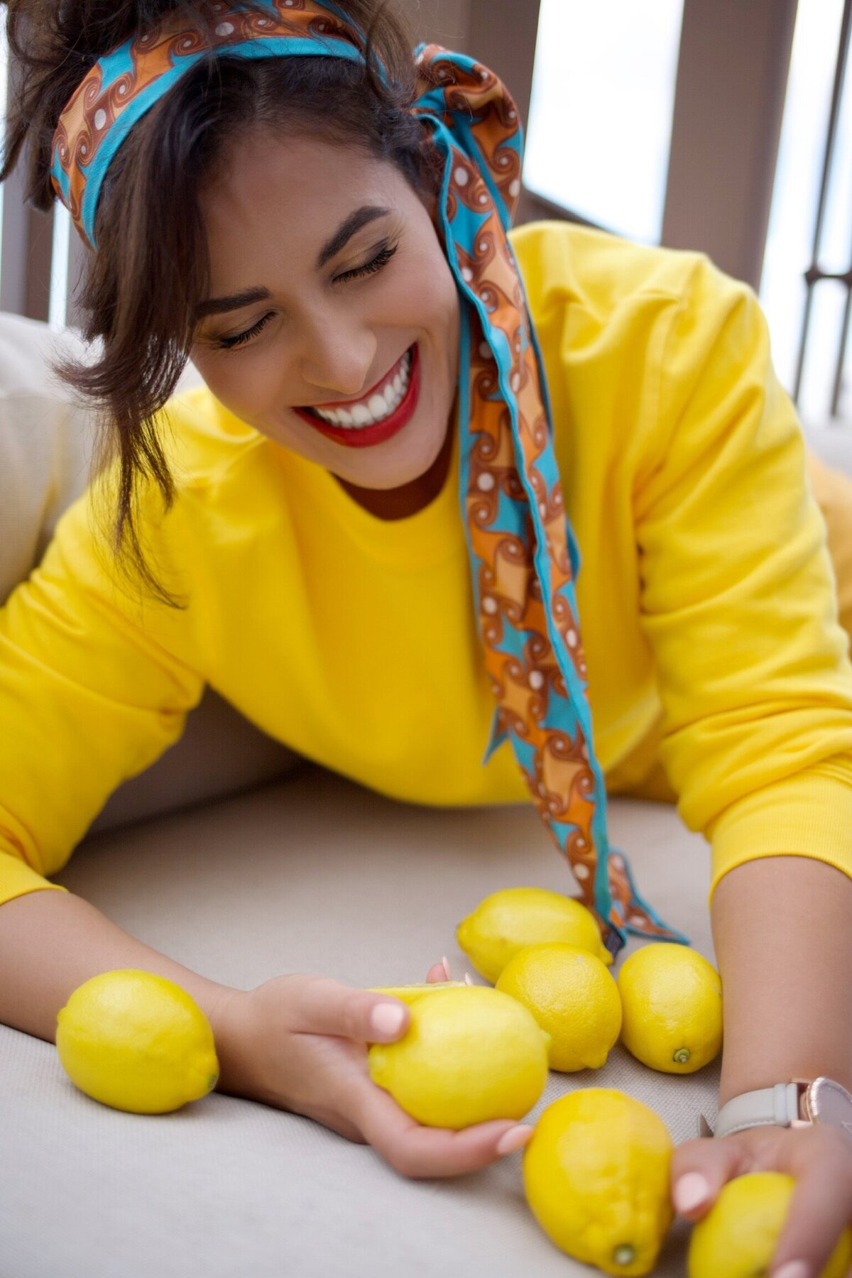 woman laying in front of lemons