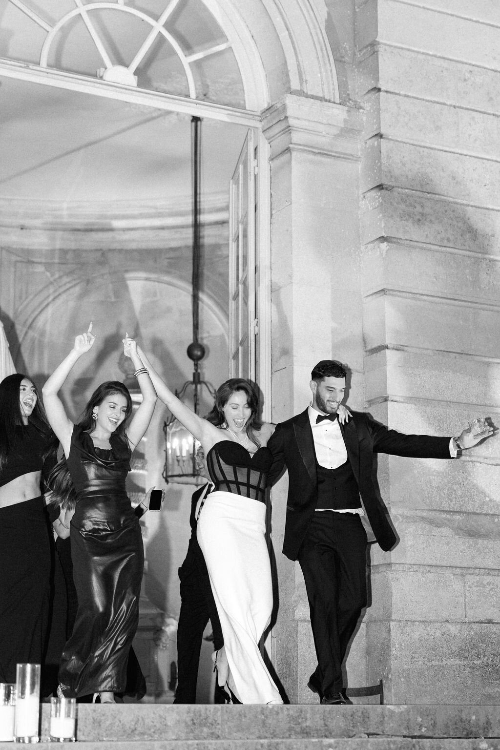 bride and groom entering their wedding reception in France captured by their columbus, ohio wedding photographer 