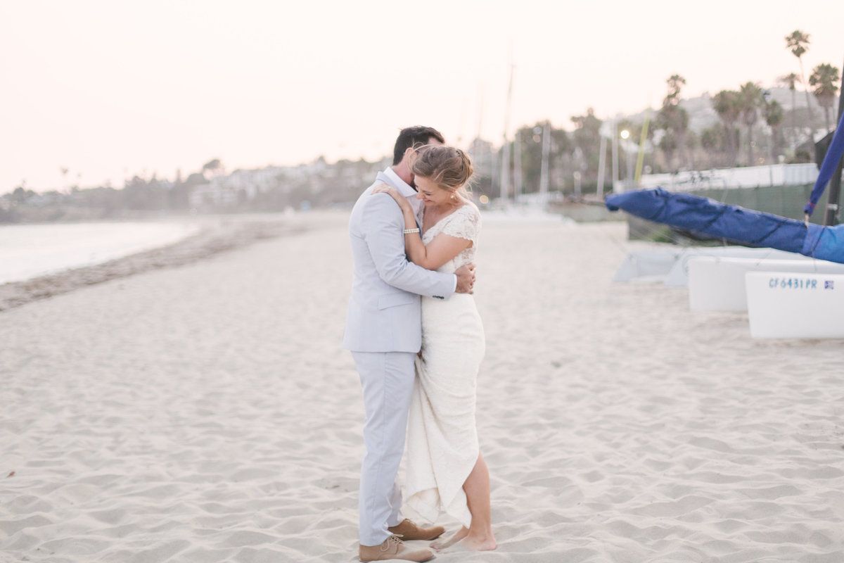 Bride and groom embrace at Santa Barbara Beach wedding
