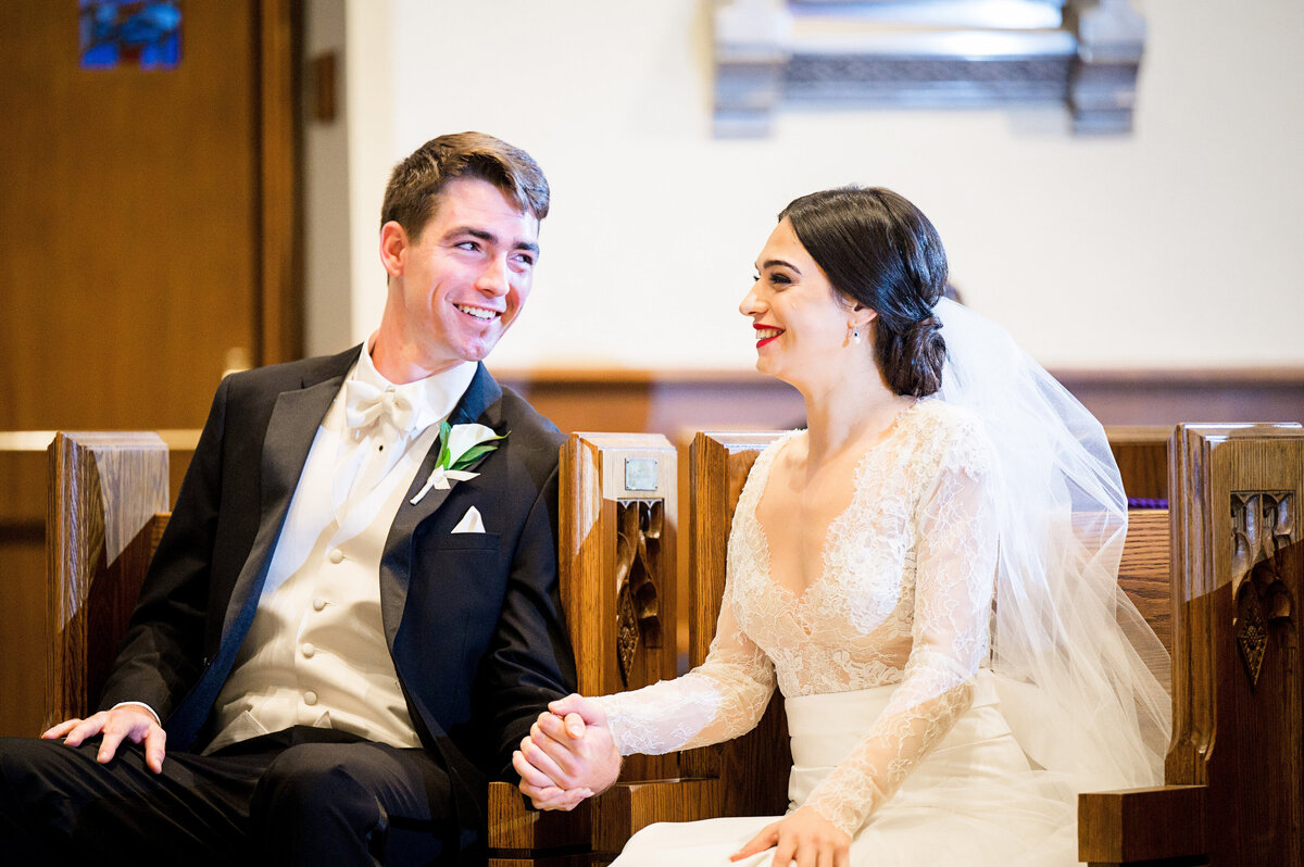 bride and groom smiling at each other during wedding ceremony