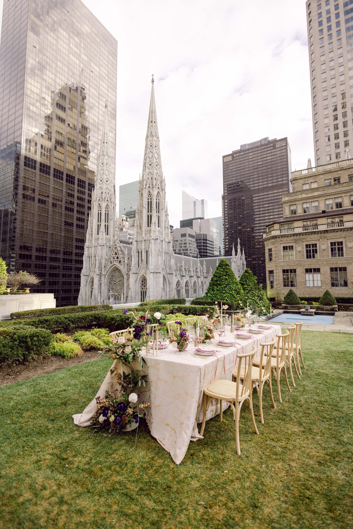 Wide photo of a reception table on a rooftop in new york