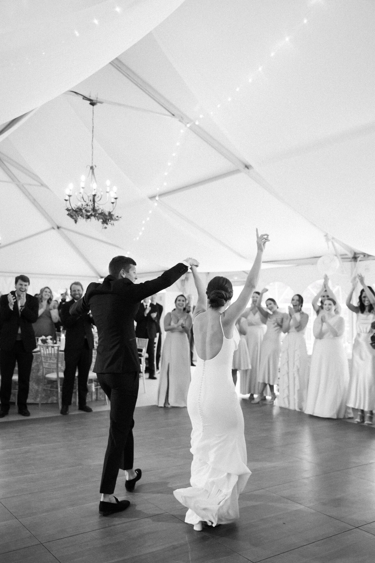 Rust Manor House Wedding | black and white image of bride and groom entering their reception