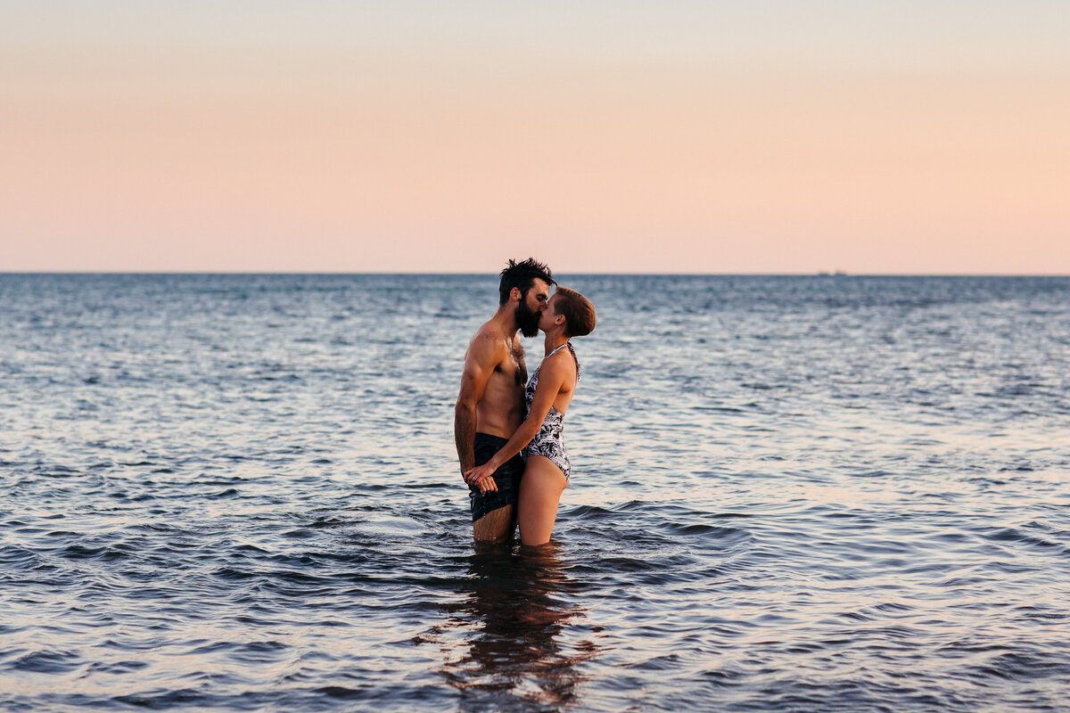 Couple kiss in the sea at Wembury Beach
