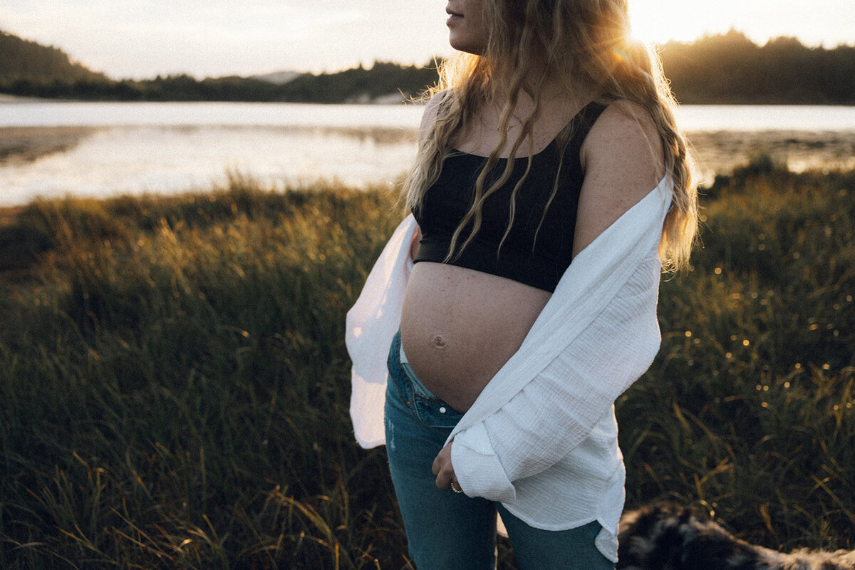 Pregnant momma twirls in the sunlight near the Oregon coast. 