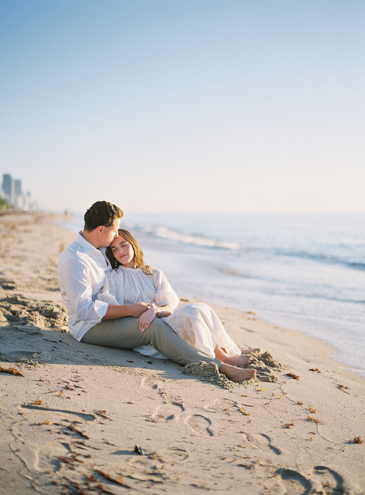 couple-sitting-on-beach-4CD-ES