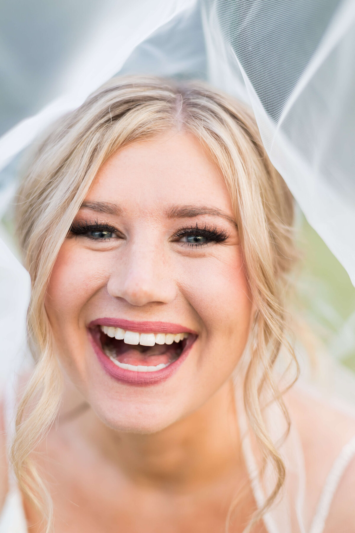 Close up of brides face laughing at  The Barn at White Oaks, Murray, Kentucky