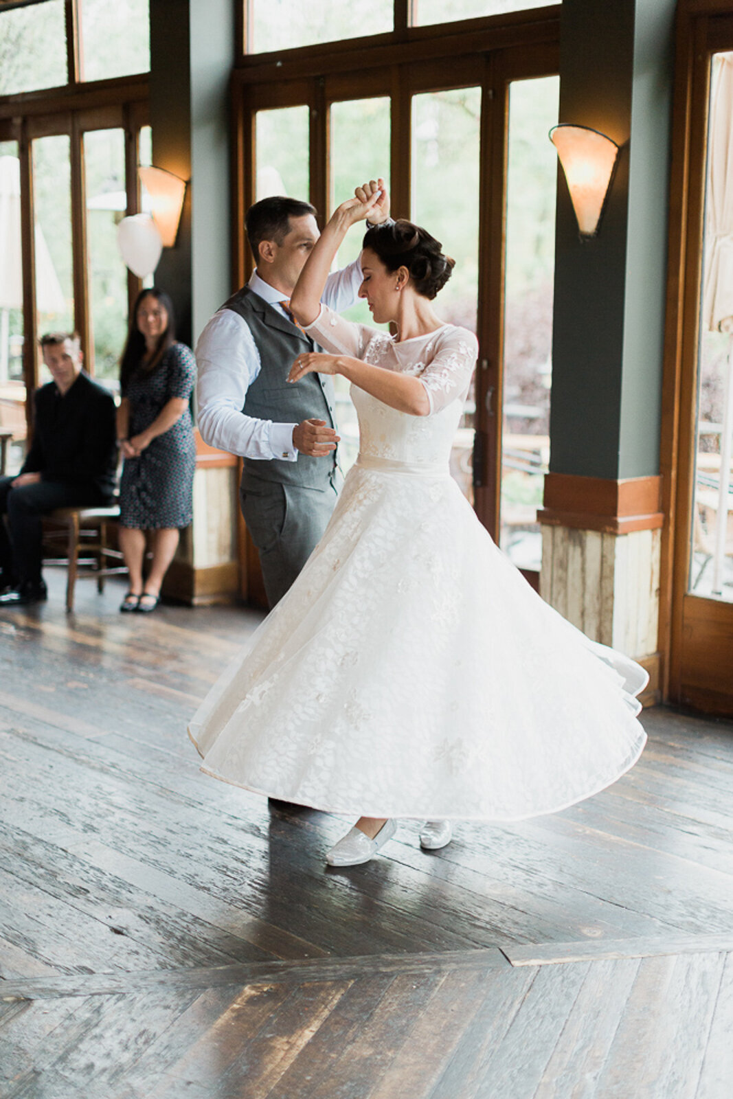 Bride and groom dancing at River Cafe, a riverside wedding venue in downtown Calgary, featured on the Brontë Bride Vendor Guide.
