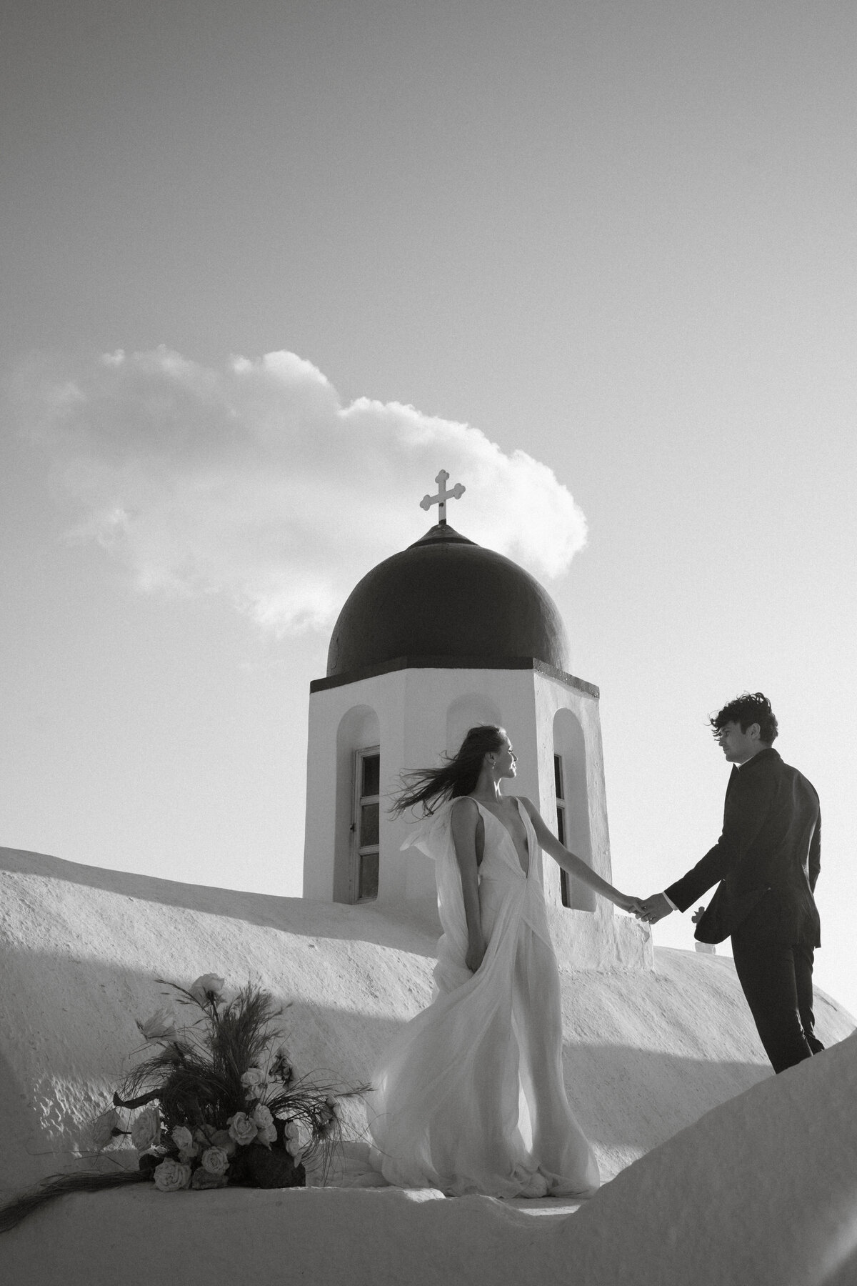 couple on a church in Santorini at sunset