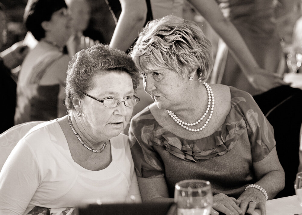Mother of the bride chatting with her friend at wedding reception