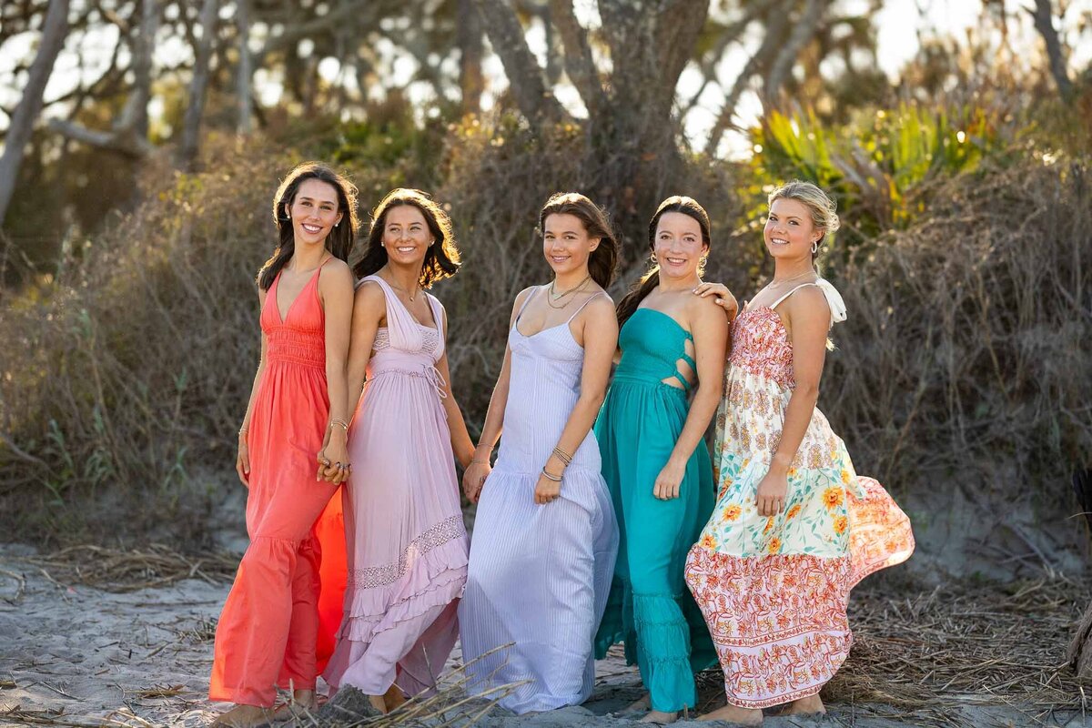 MBP Senior Team standing on the beach in long flowing dresses in Lawrence, KS