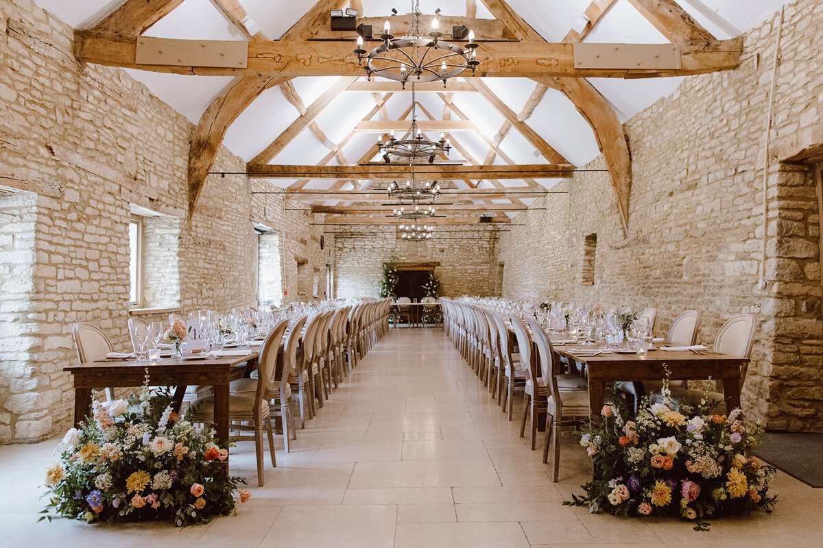 caswell-house-barn-reception-long-tables-florals-natural-light