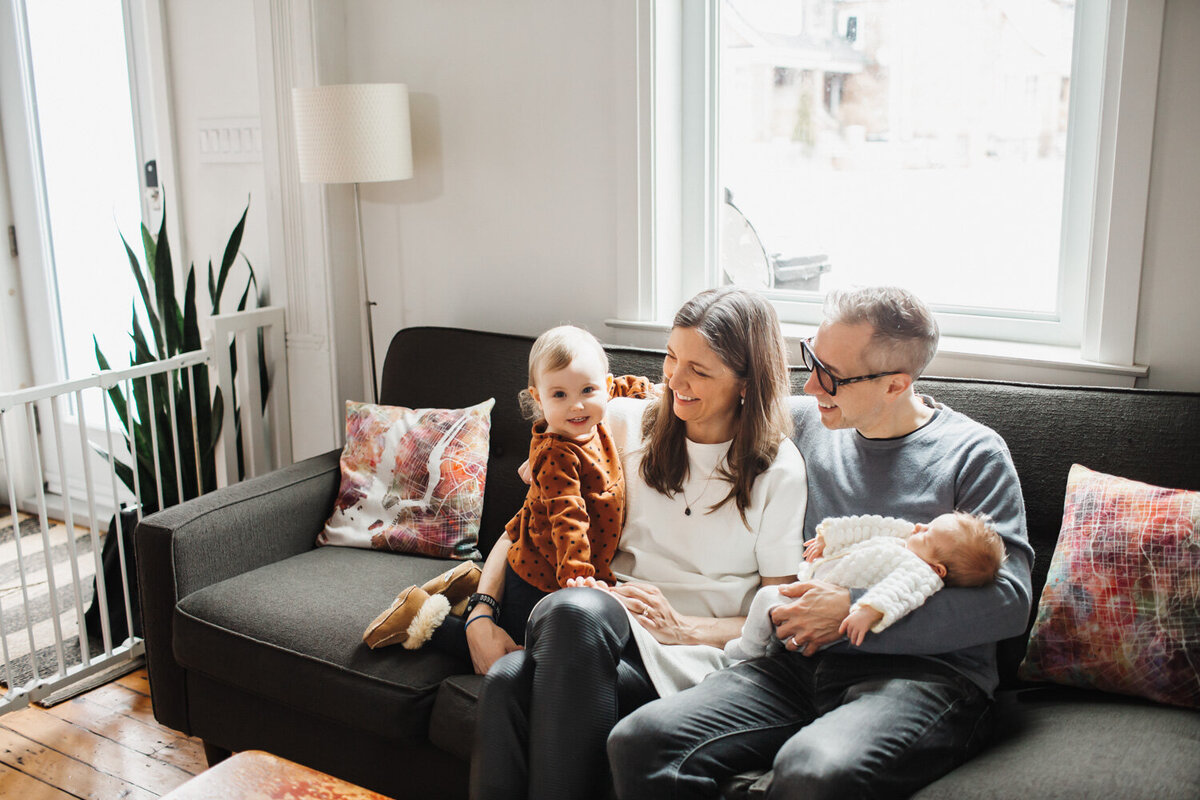 family portrait on couch during at home lifestyle newborn portrait session