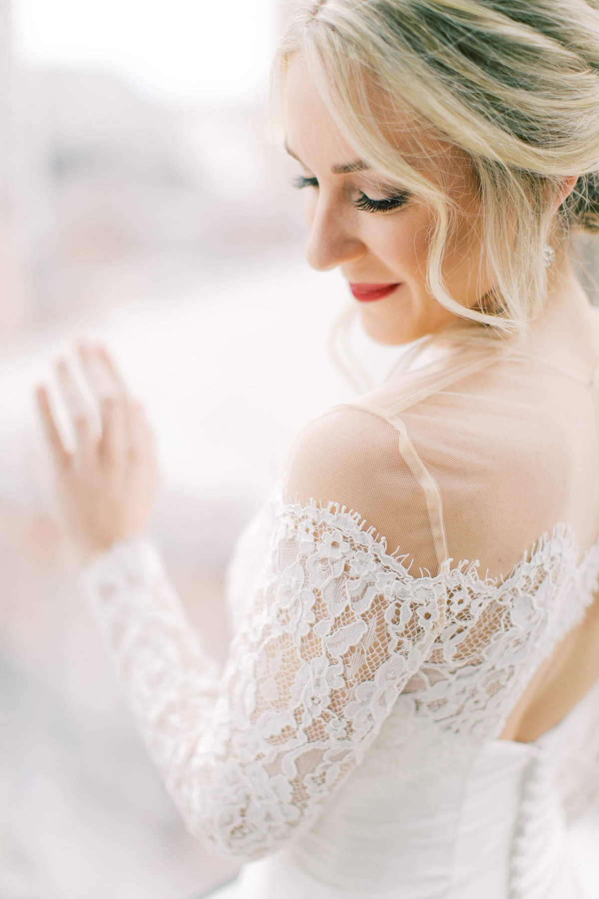 bride looking over shoulder in lace wedding gown